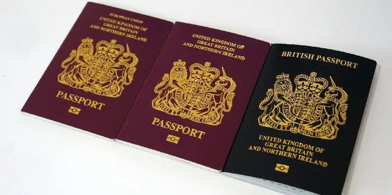 Three British passports aligned next to each other