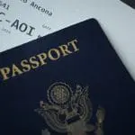 Passport on top of an airline ticket