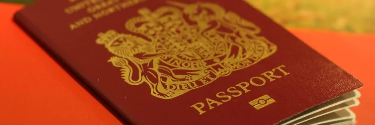 red and gold passport on red table