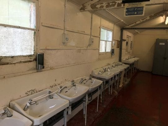 Row of sinks in decrepit room
