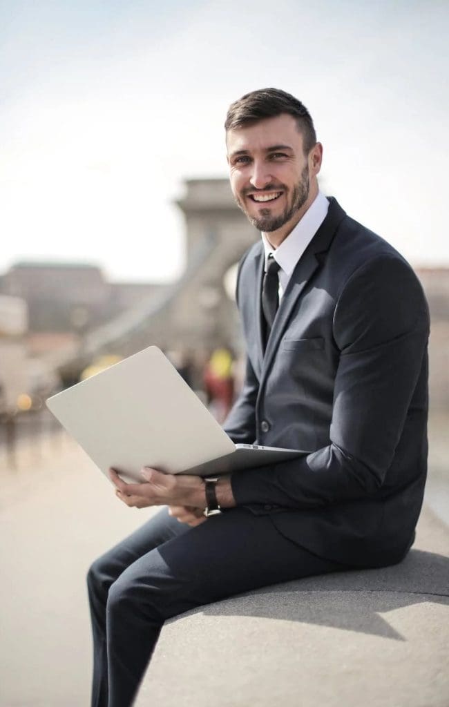a man in a business suit holding a document