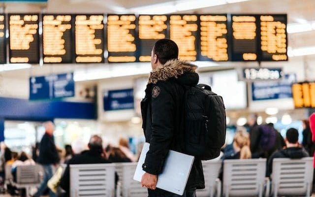 Person looking at airport arrivals departures board