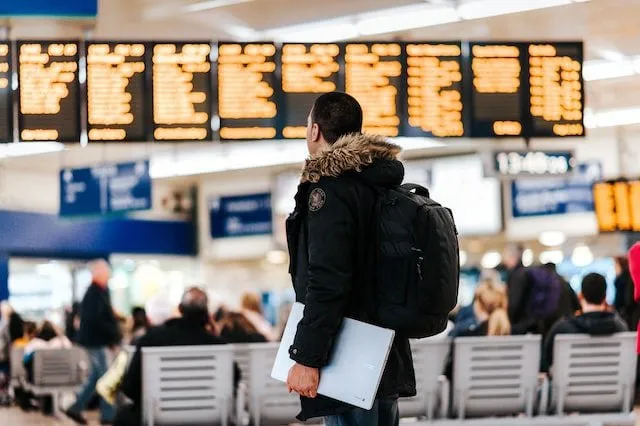 Person looking at airport arrivals departures board