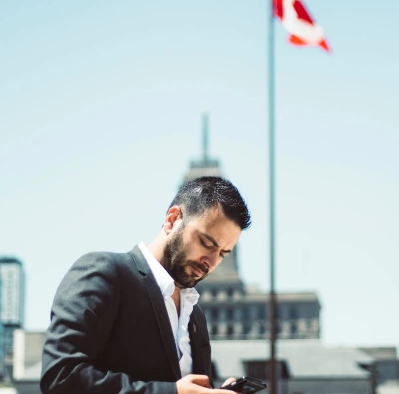 a man in a suit holding a mobile phone