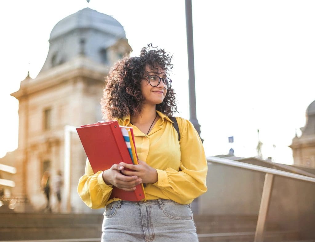 a student holding study materials