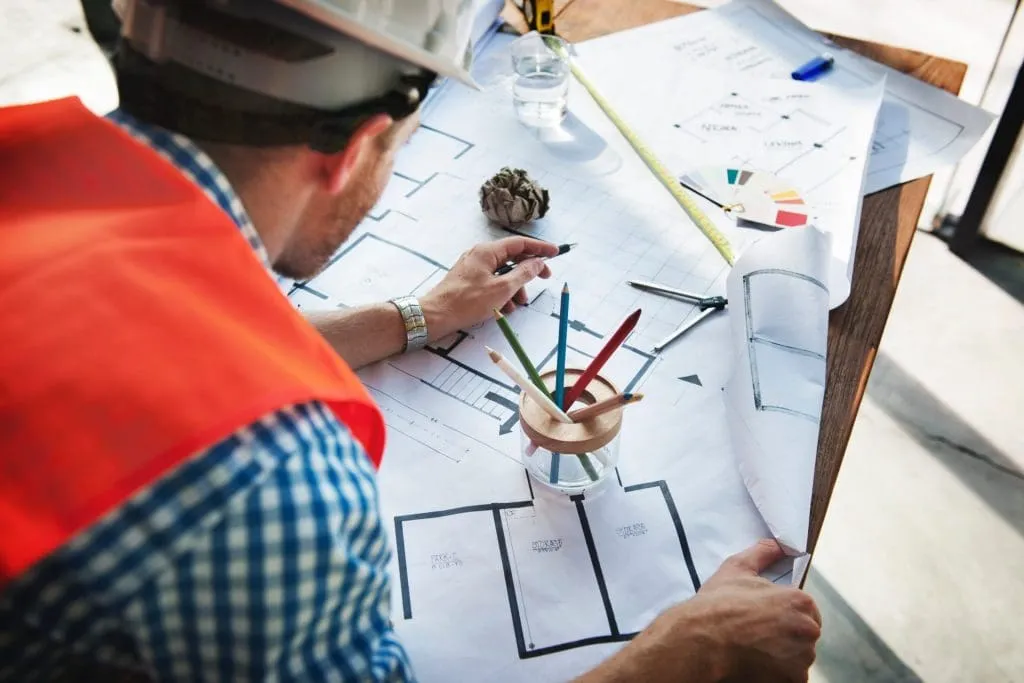 Construction worker looking at building plans
