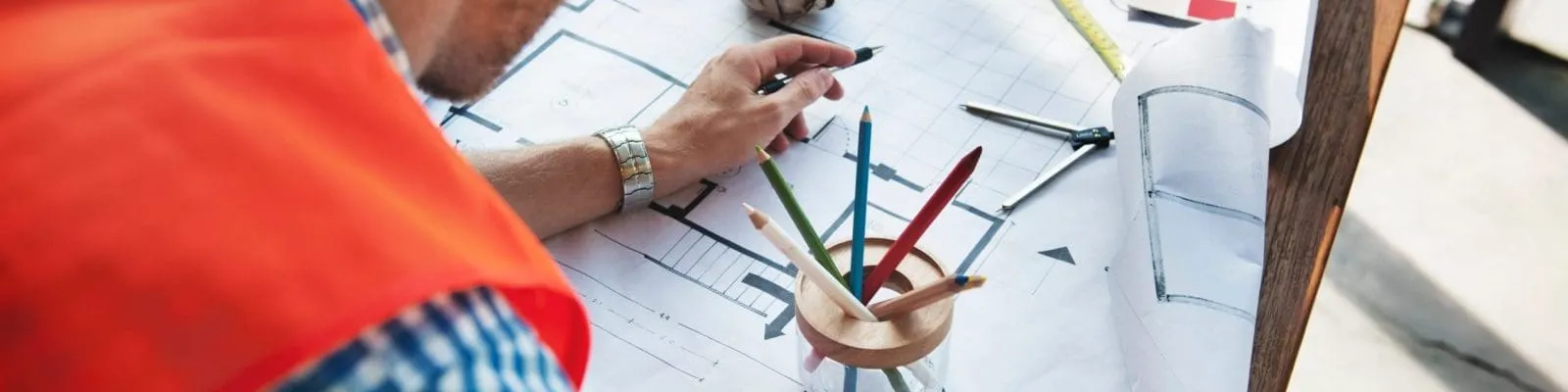 Construction worker looking at building plans