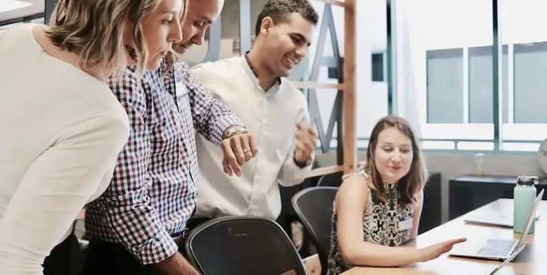 a group of employees in a meeting