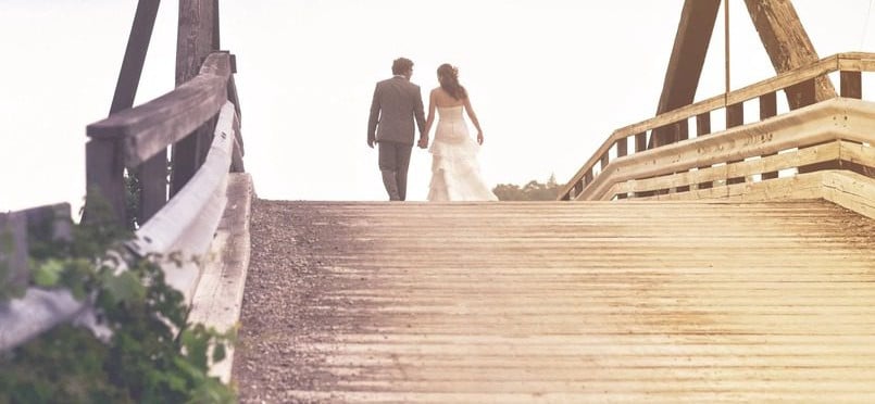 married couple walking at the bridge