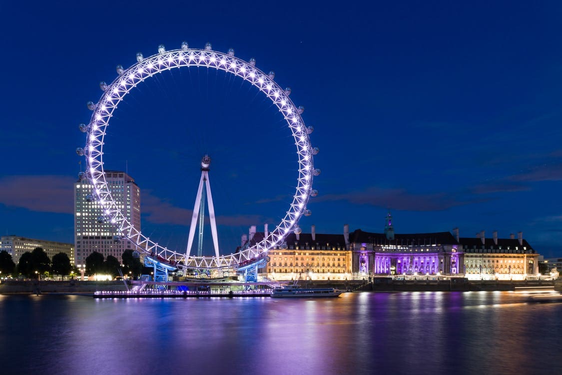 large lit-up ferris wheel against night sky
