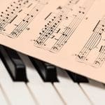 Sheet music on piano keys