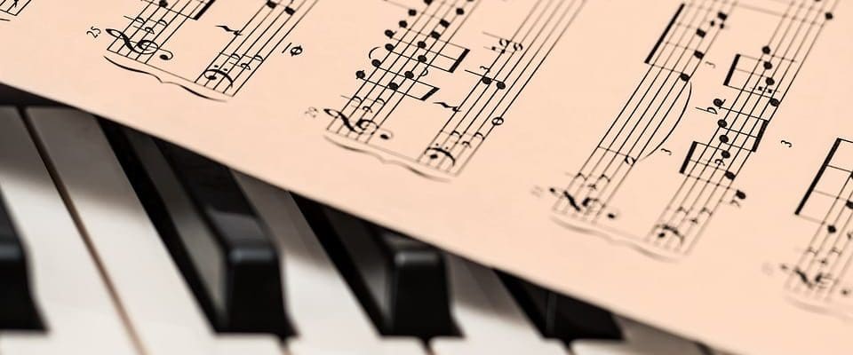 Sheet music on piano keys