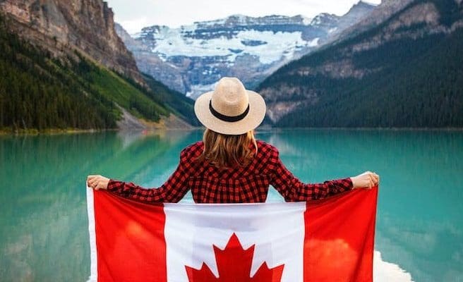 a woman holding a flag of Canada
