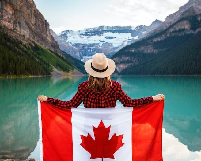 a woman holding a flag of Canada