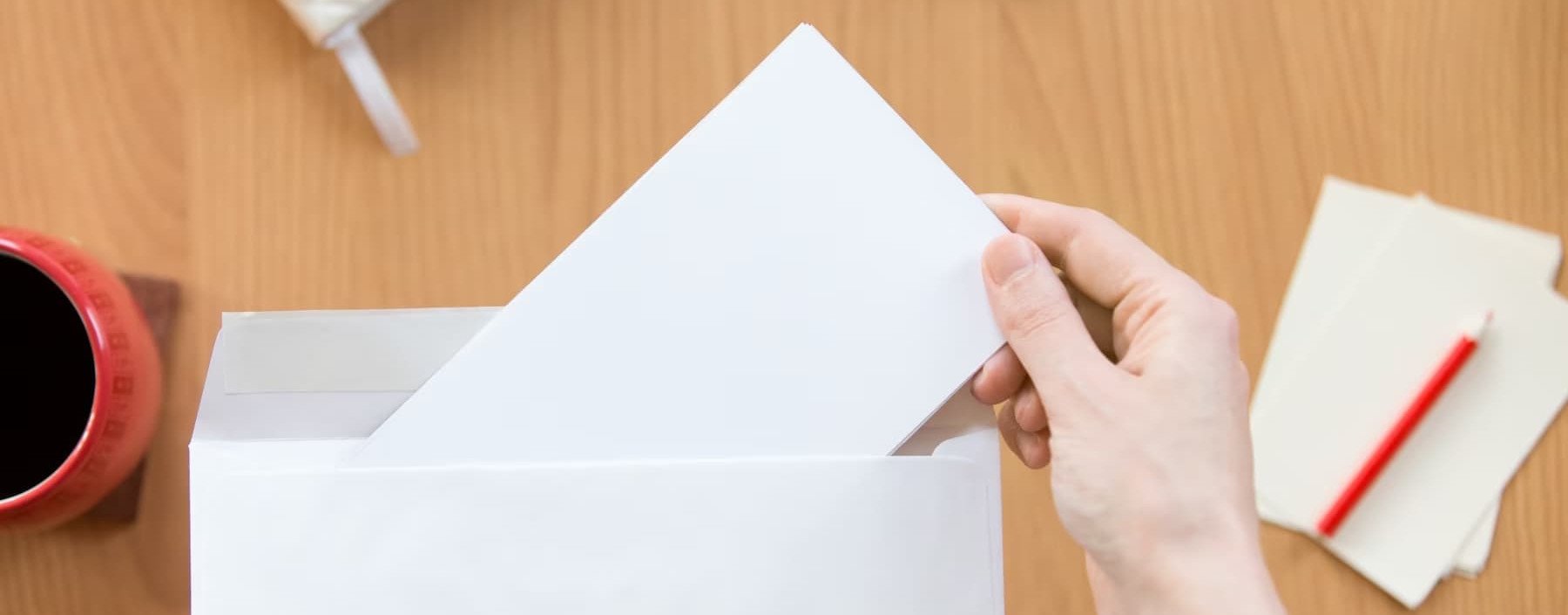 a person opening a letter