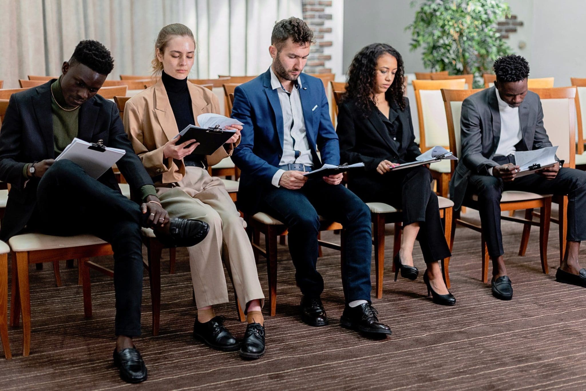a group of employees sitting while reading a document