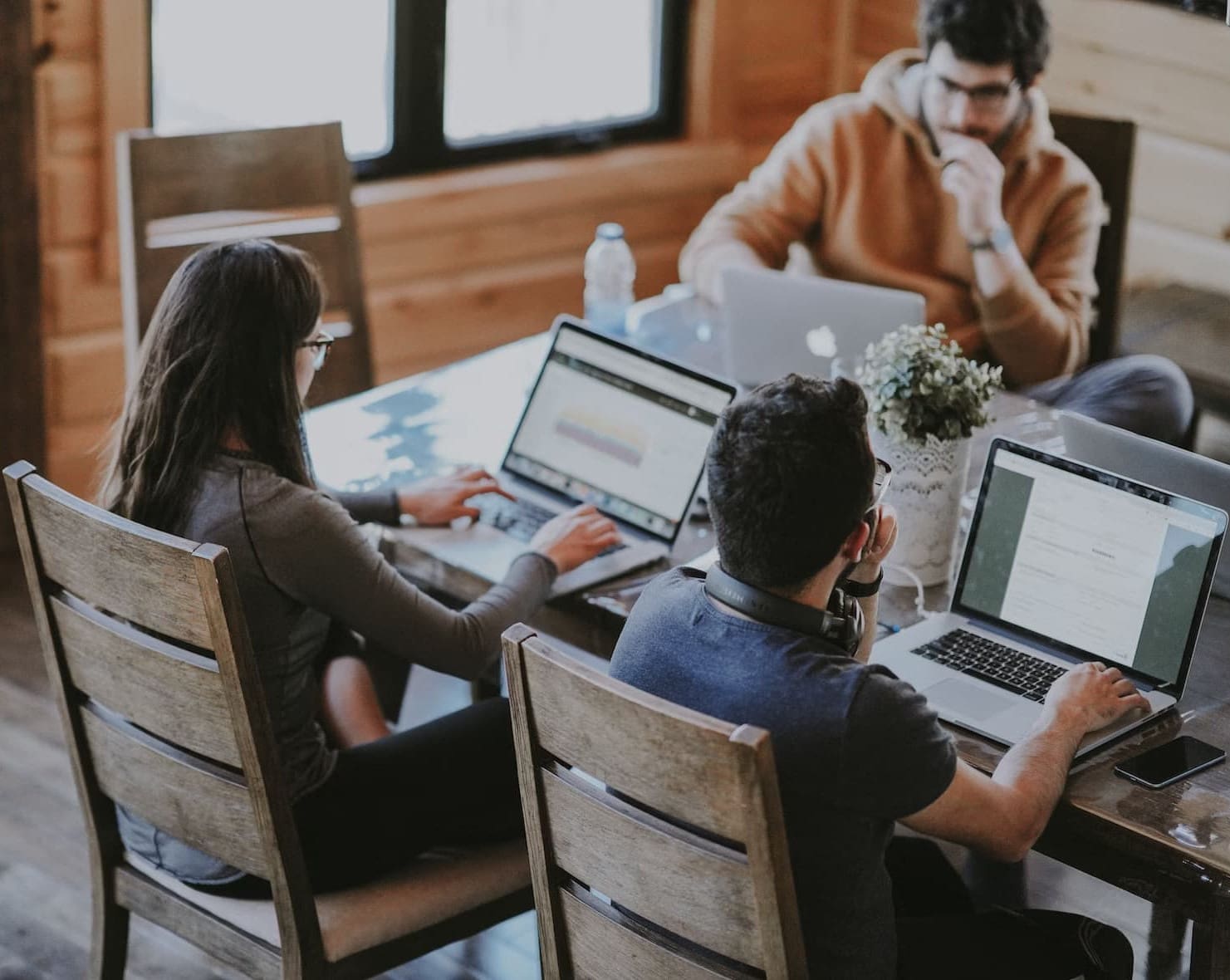 a group of employees working with a laptop