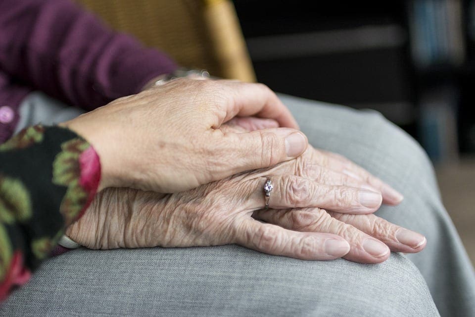 Two people holding each other.