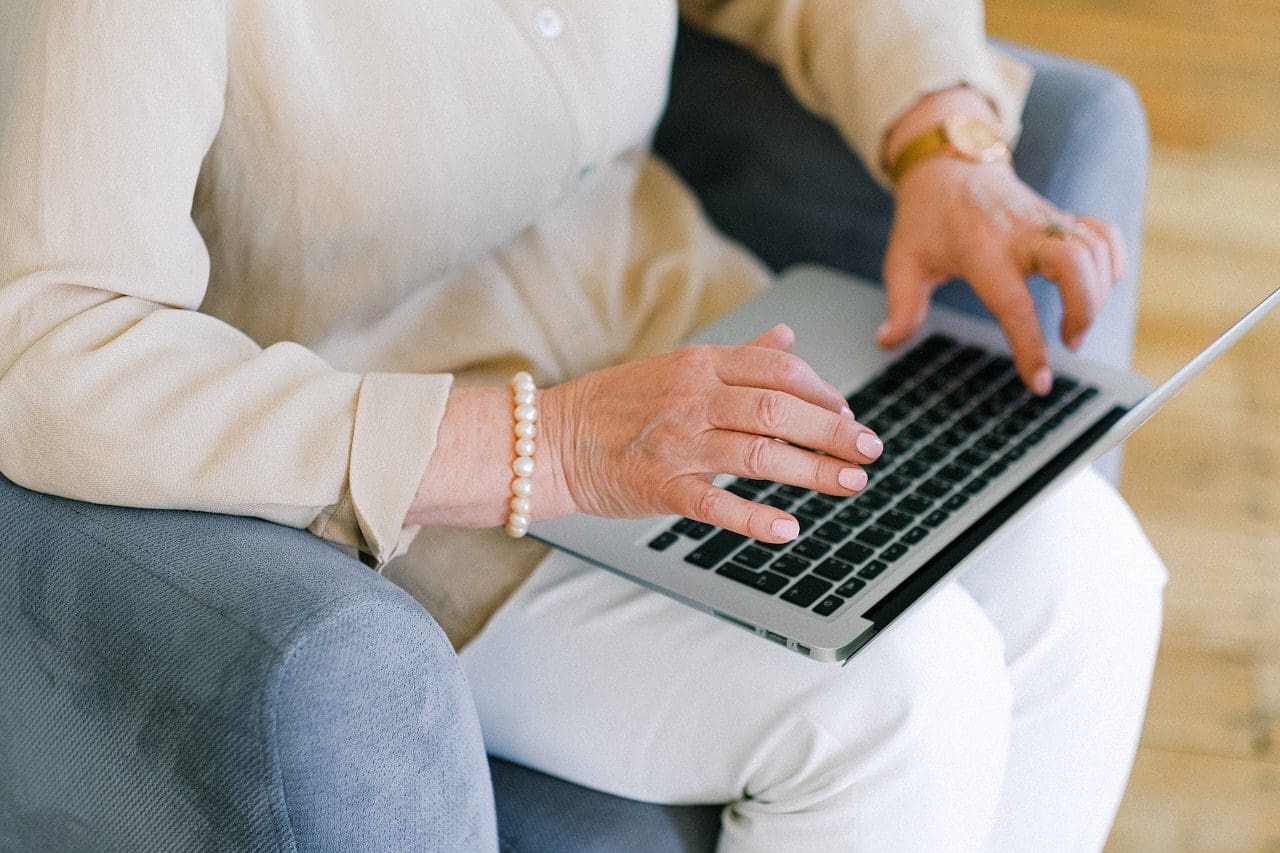 close up of hands typing on a laptop