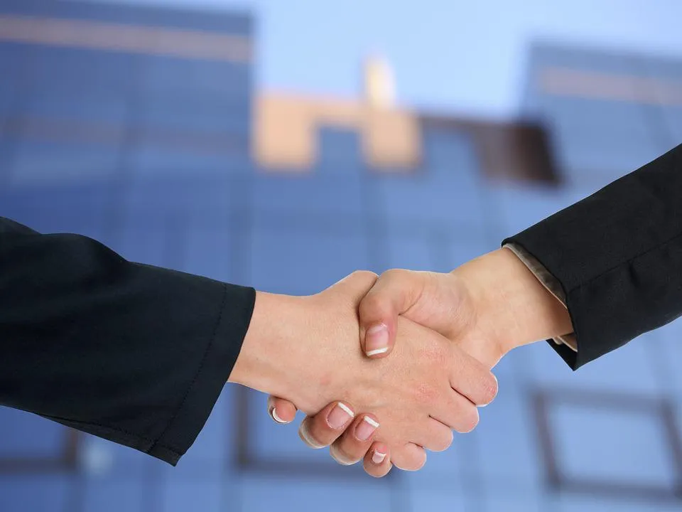 two people in suits shaking hands