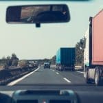 Blue and Red Freight Trucks on Road
