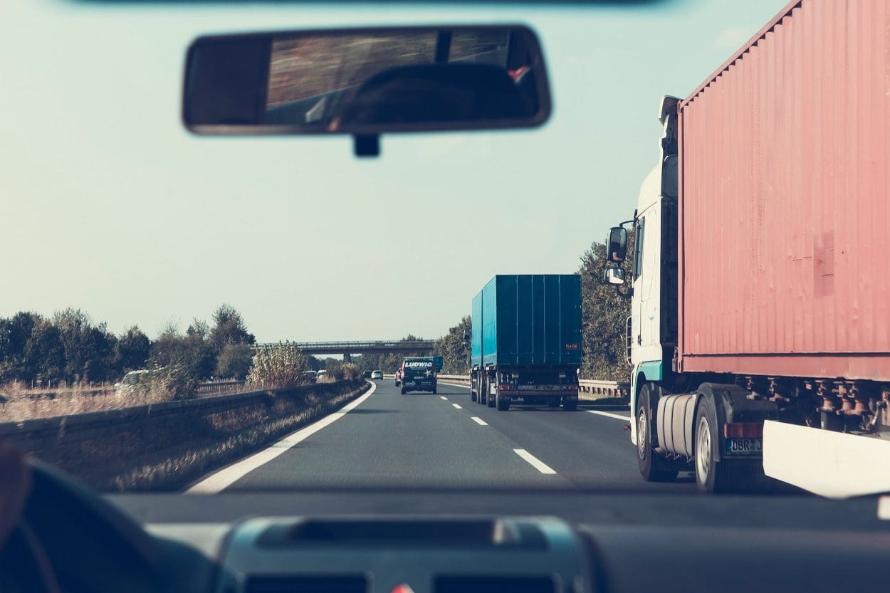 Blue and Red Freight Trucks on Road