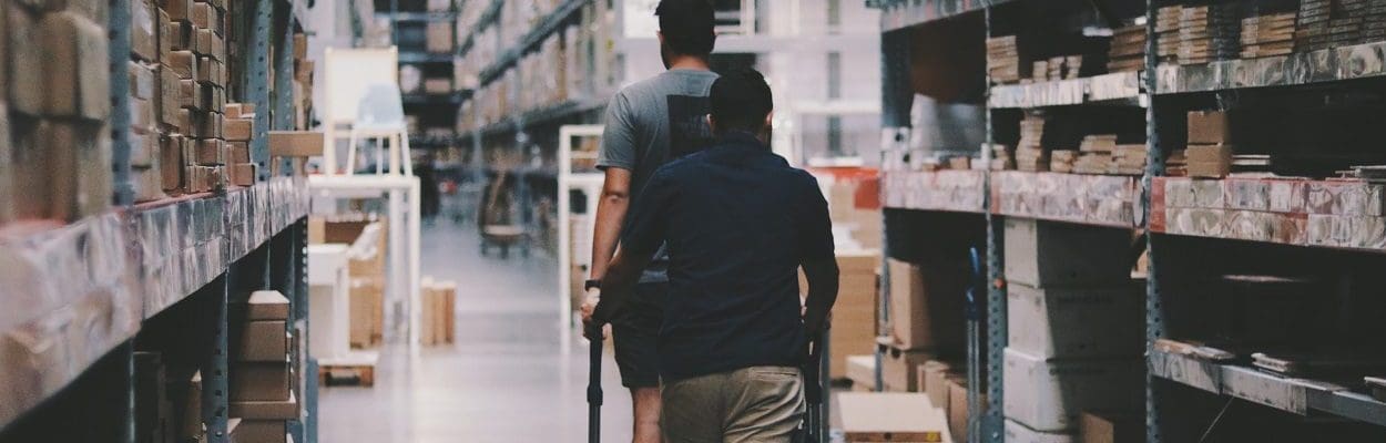 Two people walking in a large warehouse