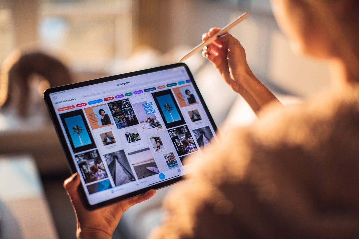 Close up of woman holding a pencil and tablet computer