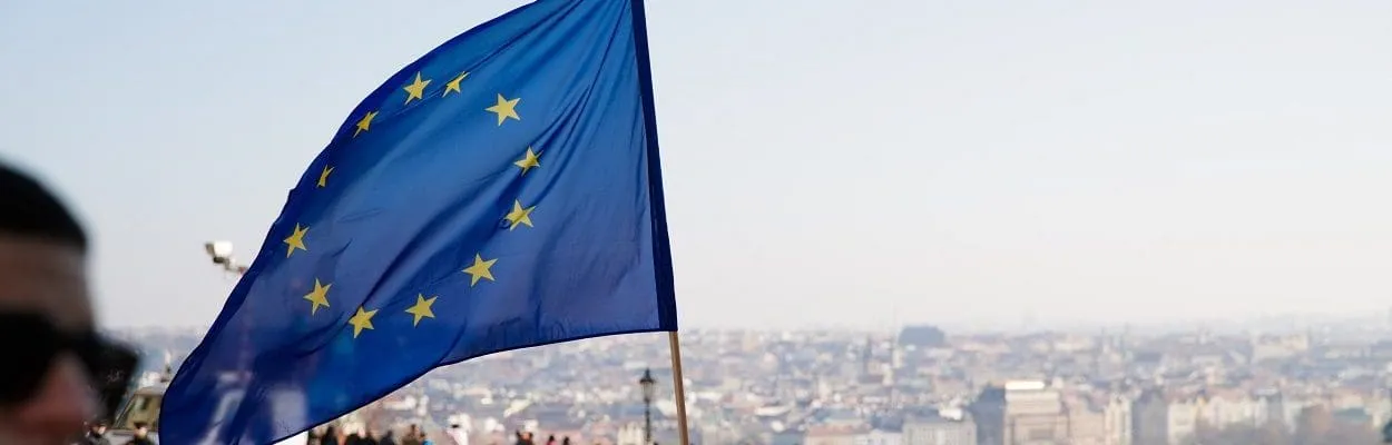 large crowd with a european union flag under a blue sky