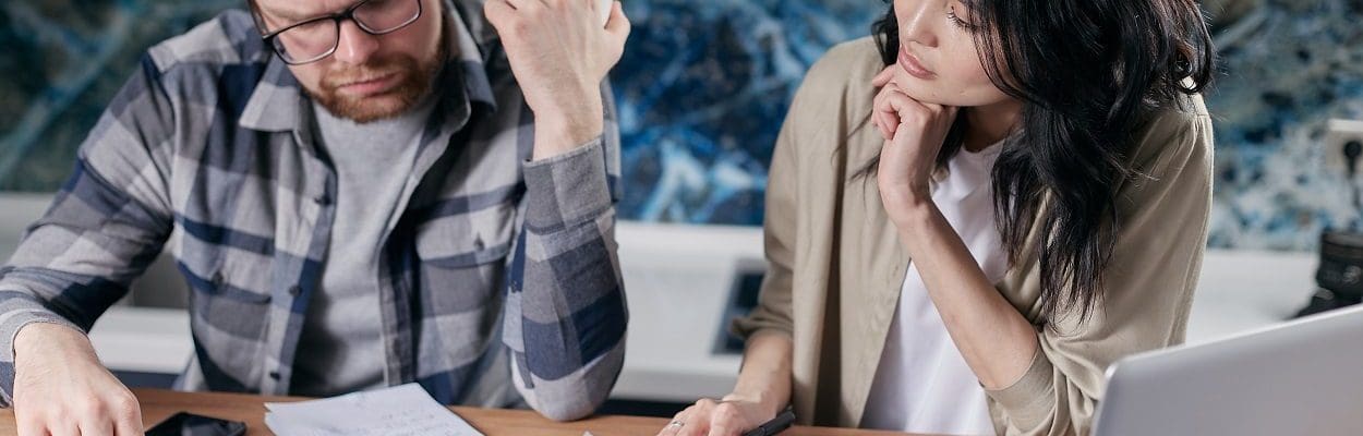 couple looking at bills and calculator on table