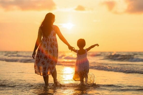 a mother and child at the beach