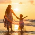 a mother and child at the beach
