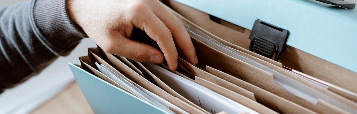 Person choosing document in folder