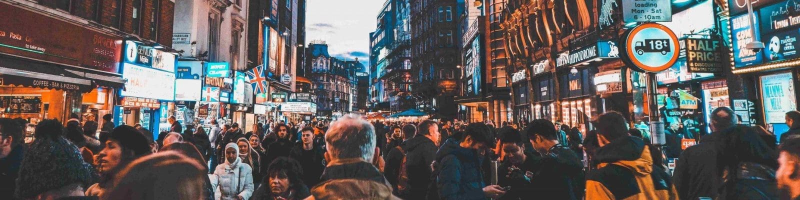 crowd in busy city street at dusk