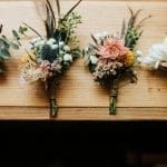 four bouquets on a wooden platform