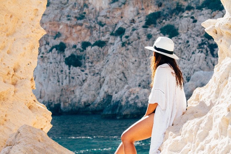 Woman sitting on rock