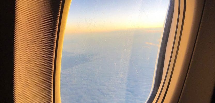 View from plane window over clouds