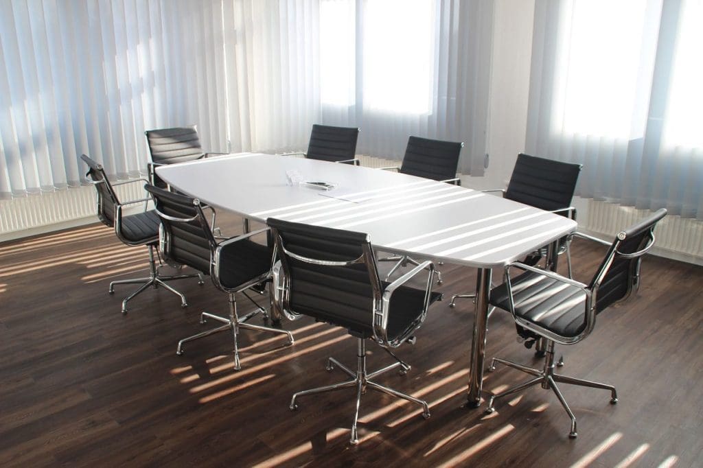 office chairs around a large boardroom desk