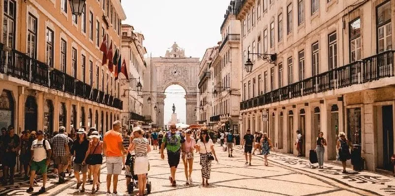 People walking amidst Portuguese architecture