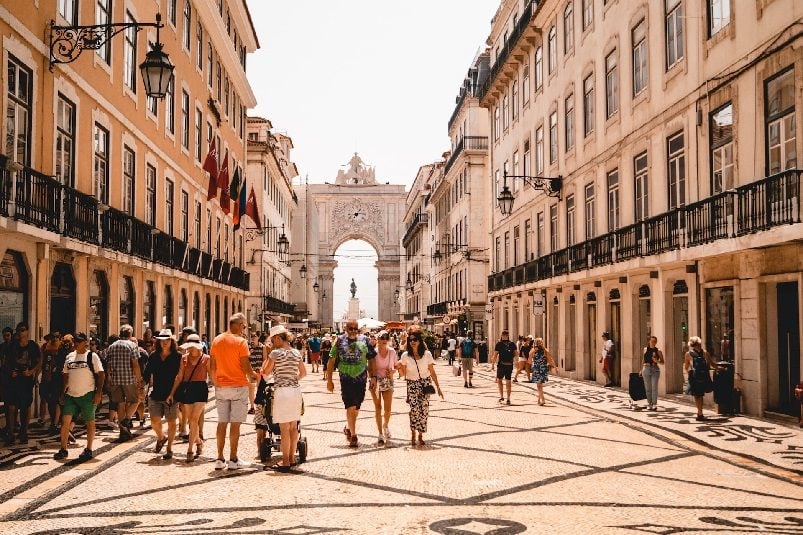 People walking amidst Portuguese architecture
