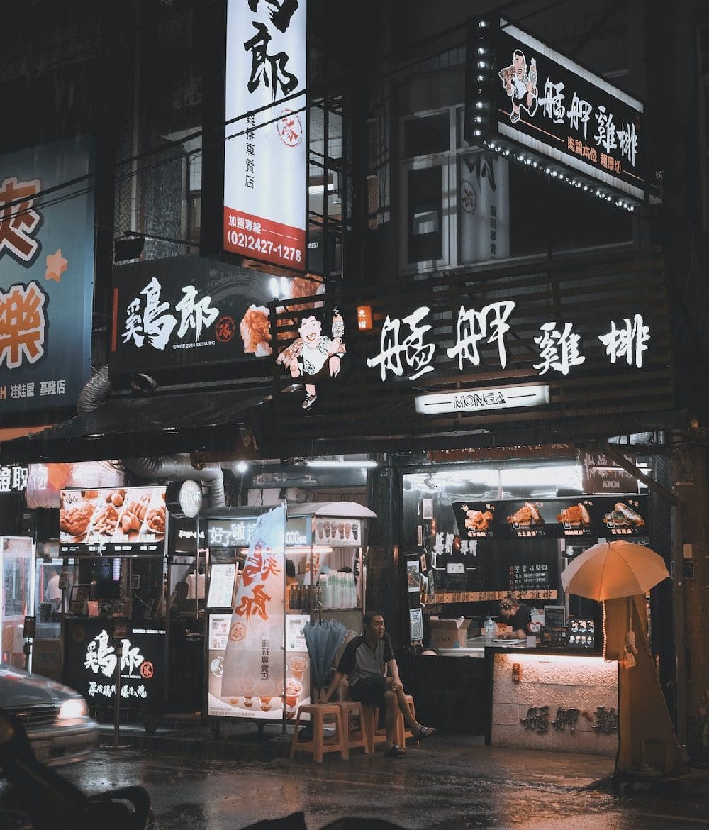 Man sitting outside fast-food restaurant in Taiwan