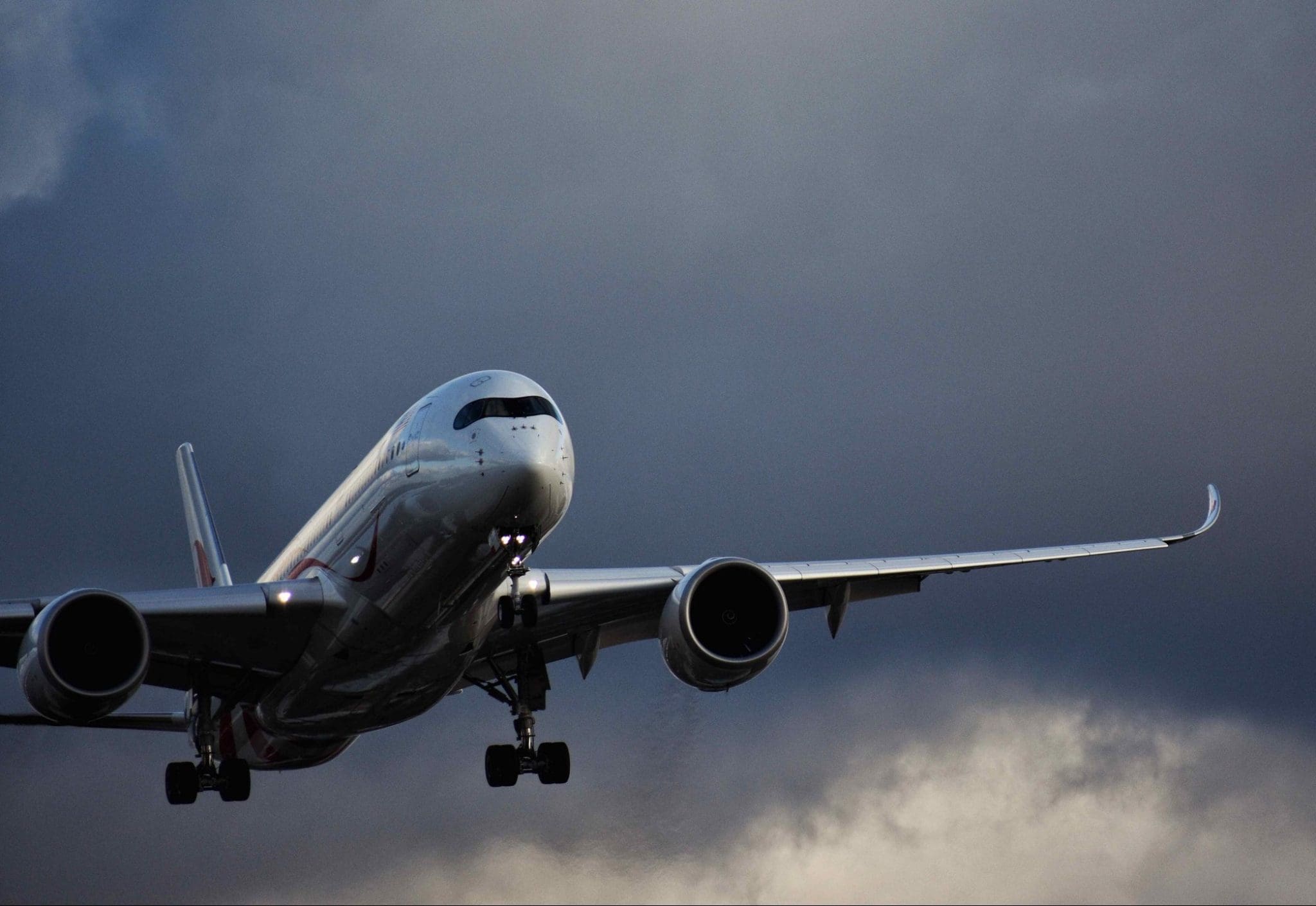 airplane flying against grey sky