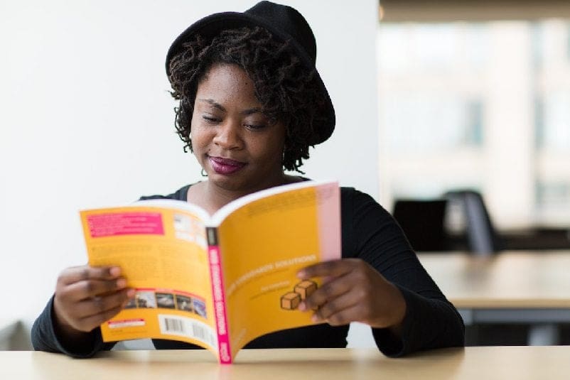 Student reading through textbook