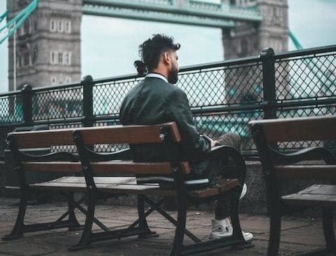 Tourist sitting down by Tower Bridge