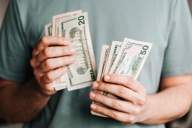 Man holding money in both hands