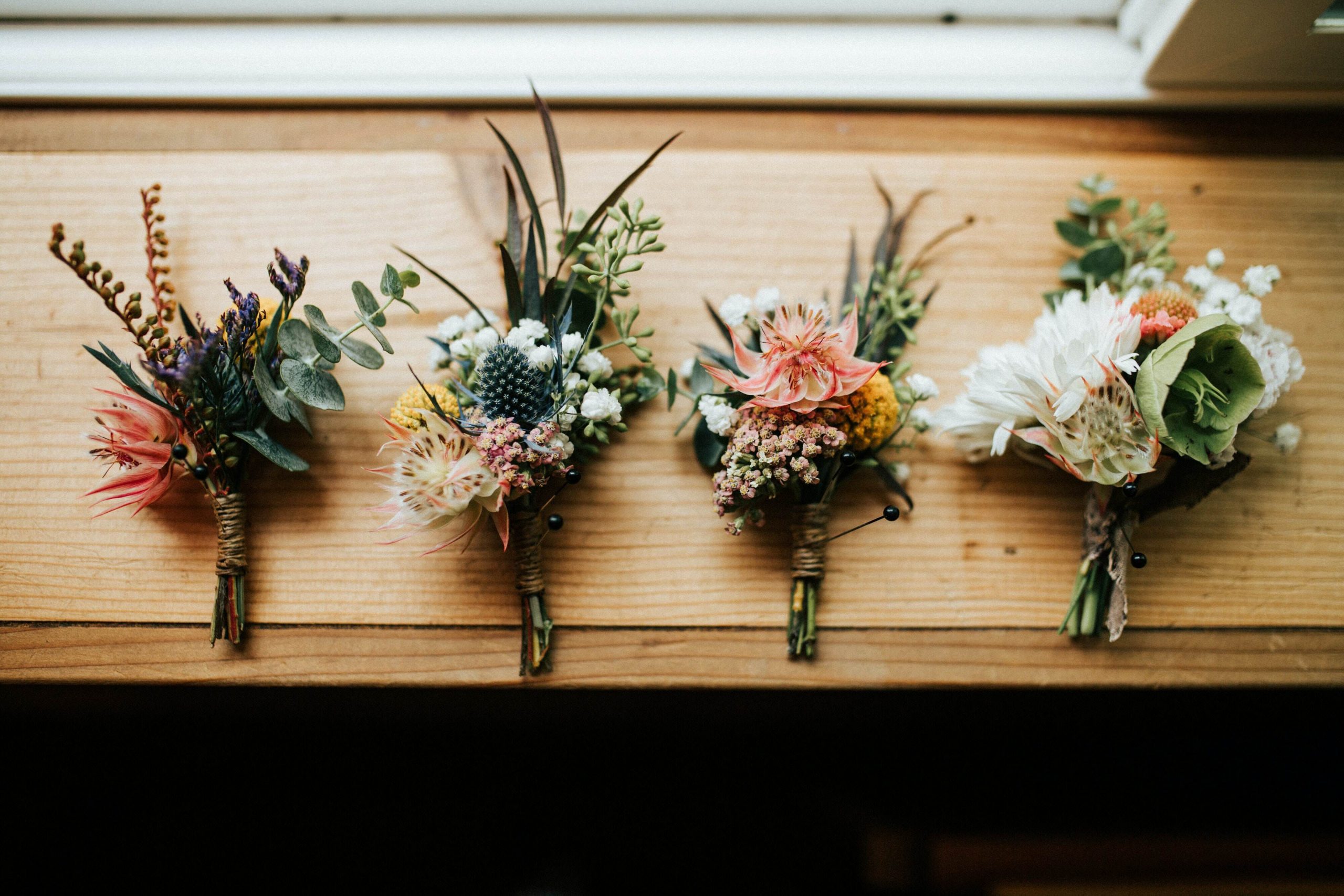 four bouquets on a wooden platform
