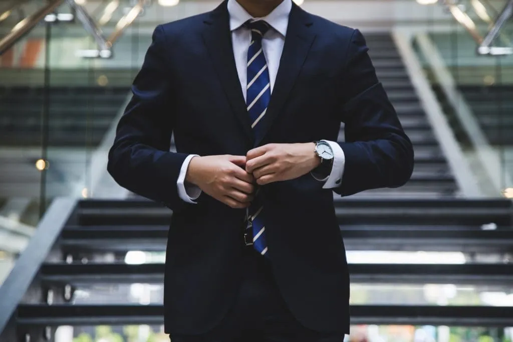 Man buttoning his blazer, 