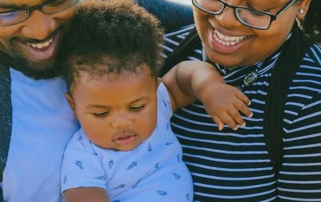 Parents carrying child together