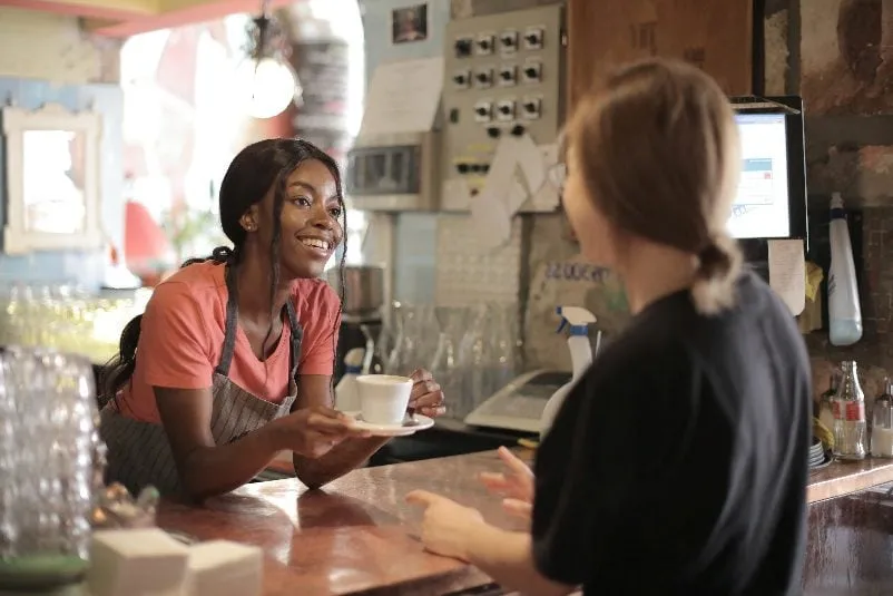 Barista serving coffee