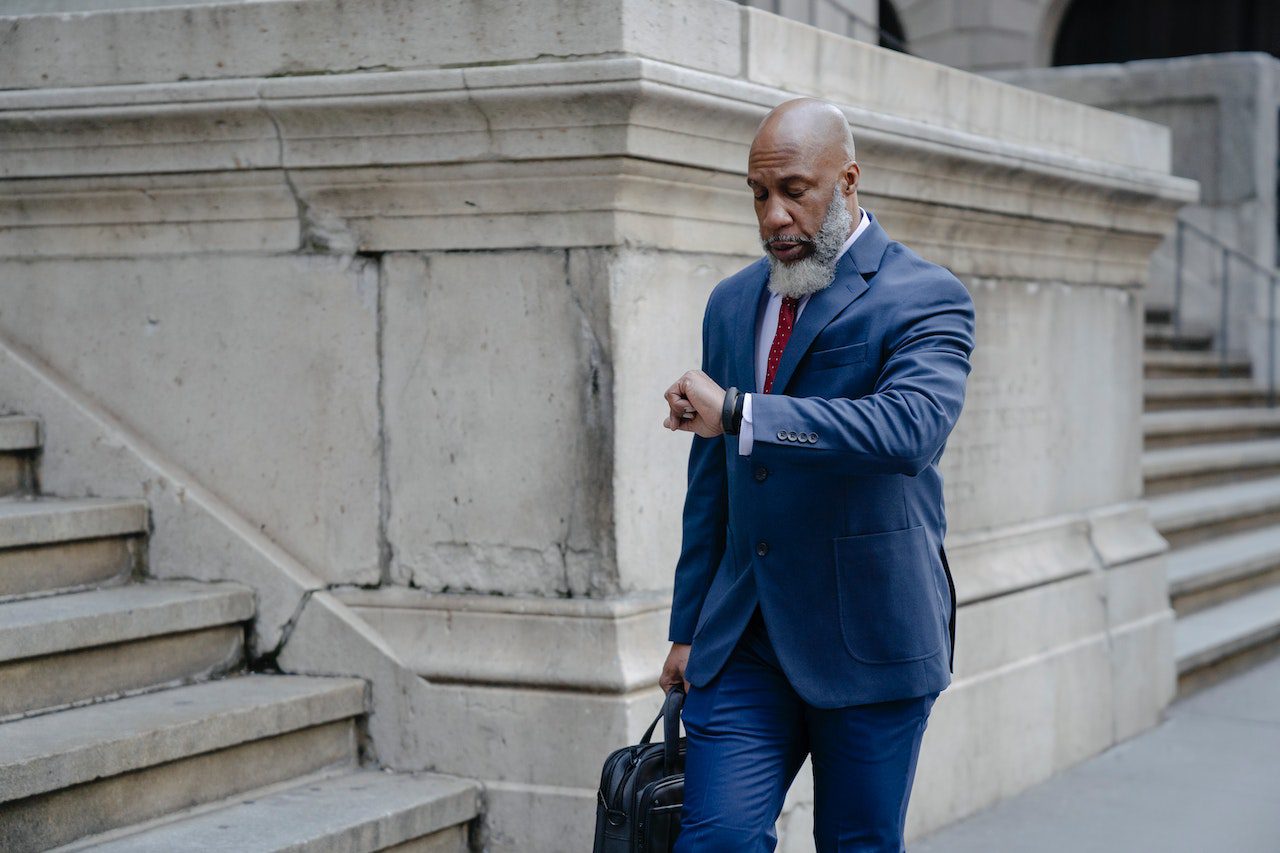 Man in suit checking time